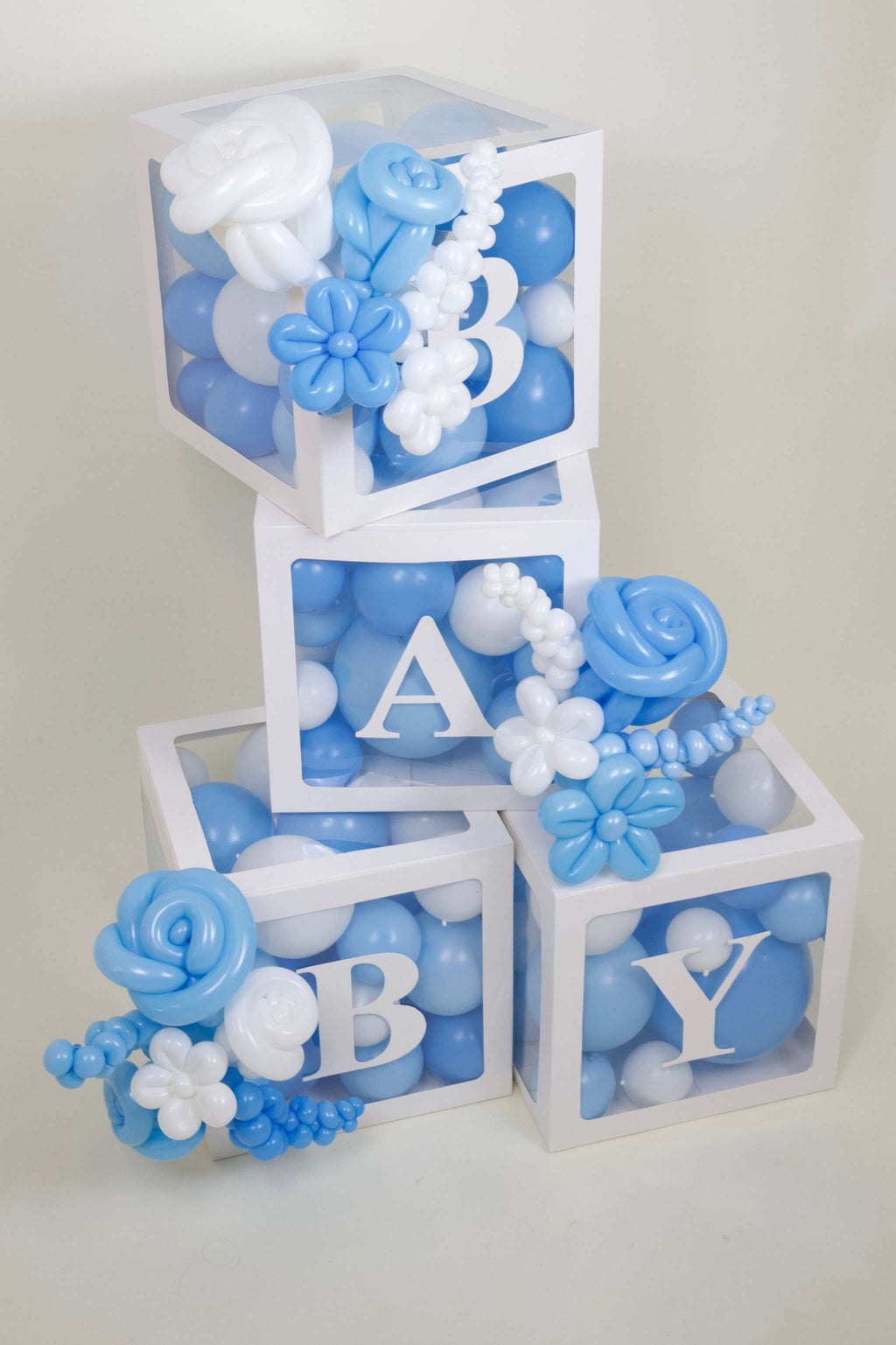 Blue white baby balloon box display with BABY boxes and balloon garland