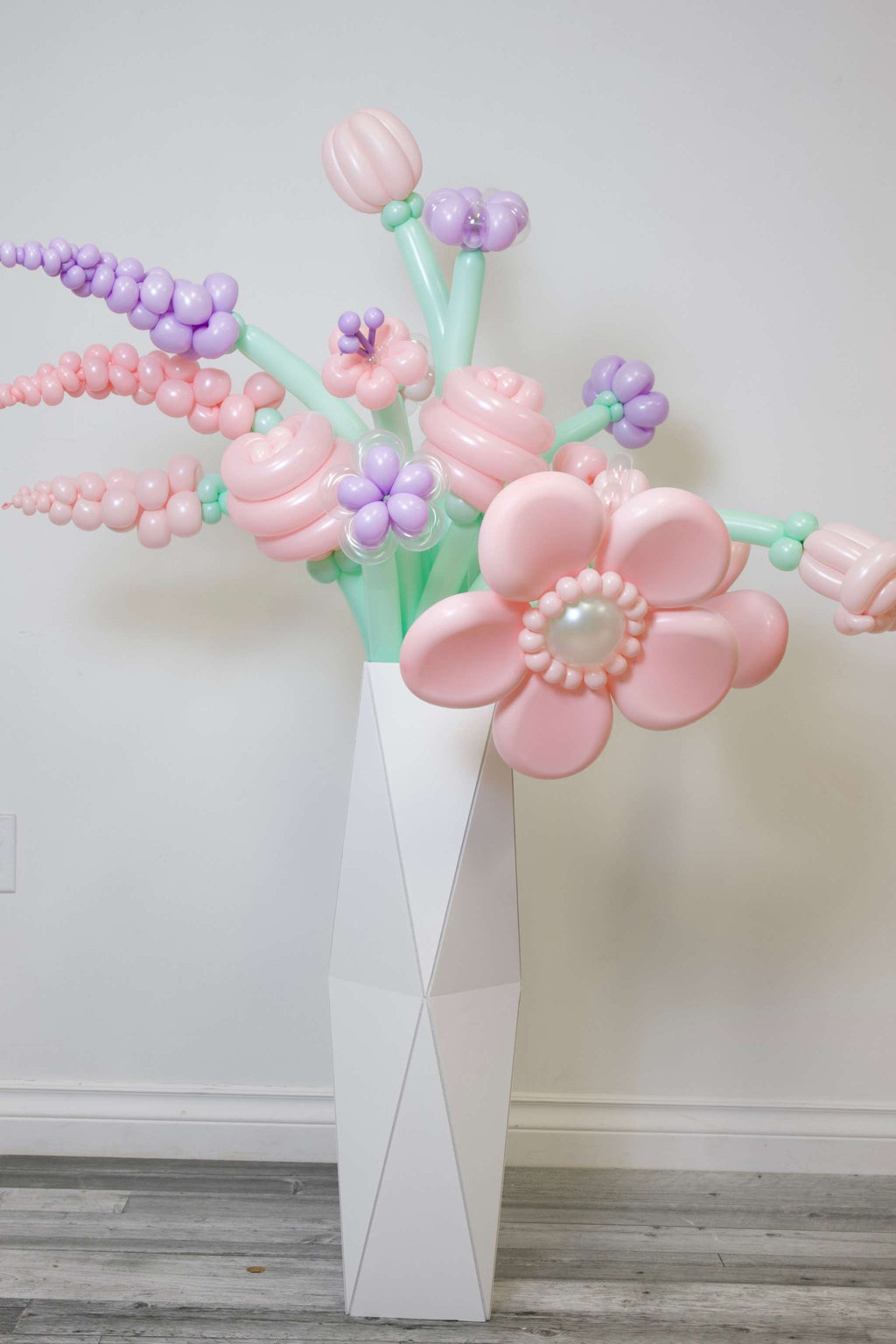 Handmade pink and purple balloon flowers arrangement in a vase for elegant balloon gift decor in Toronto