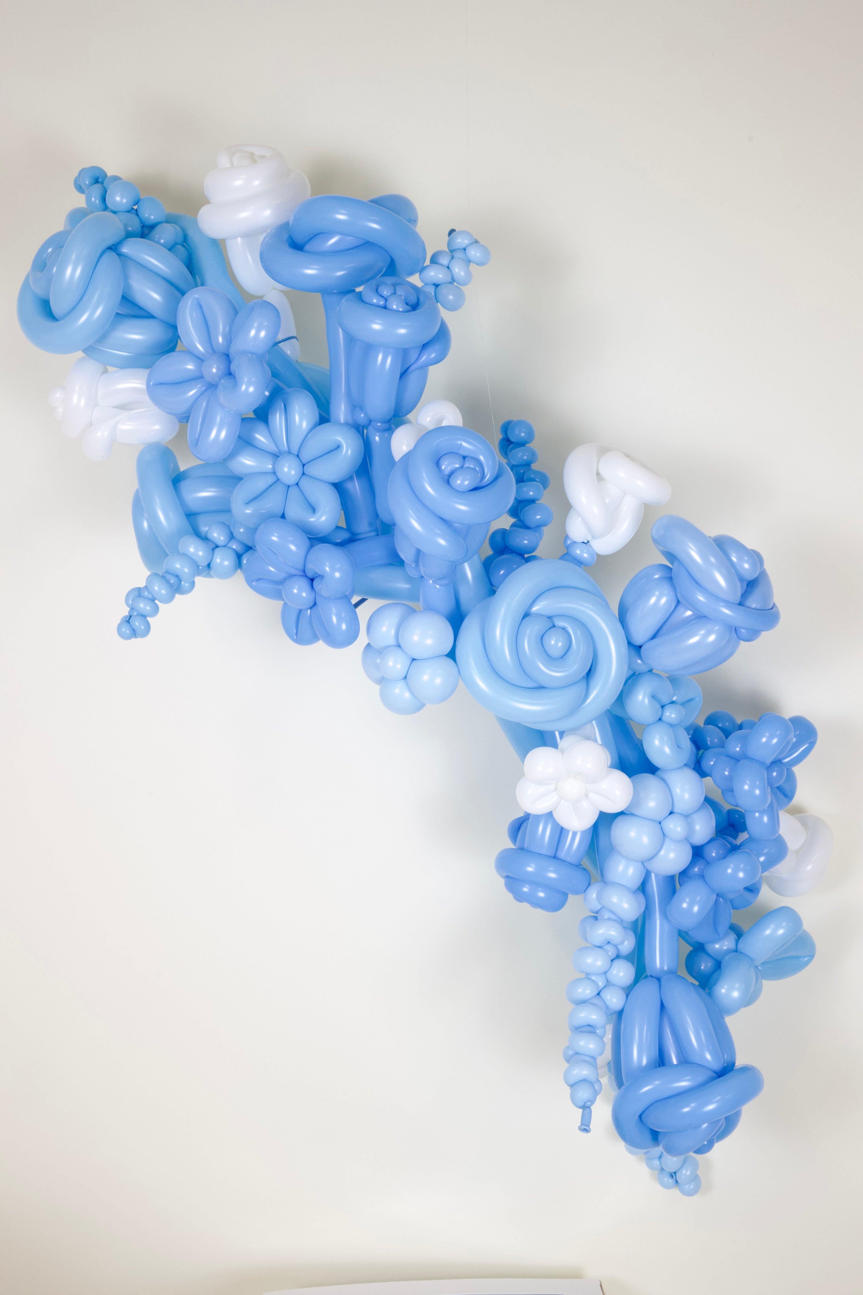 Blue balloon flower arrangement on a white background