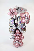 Butterfly Balloon Column with rose gold balloons, iridescent butterfly accents, oversized balloon flowers, and elegant event decor