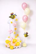 1st Birthday Balloon Stack with bee balloons, white number balloon, pink and yellow balloon flowers in Toronto