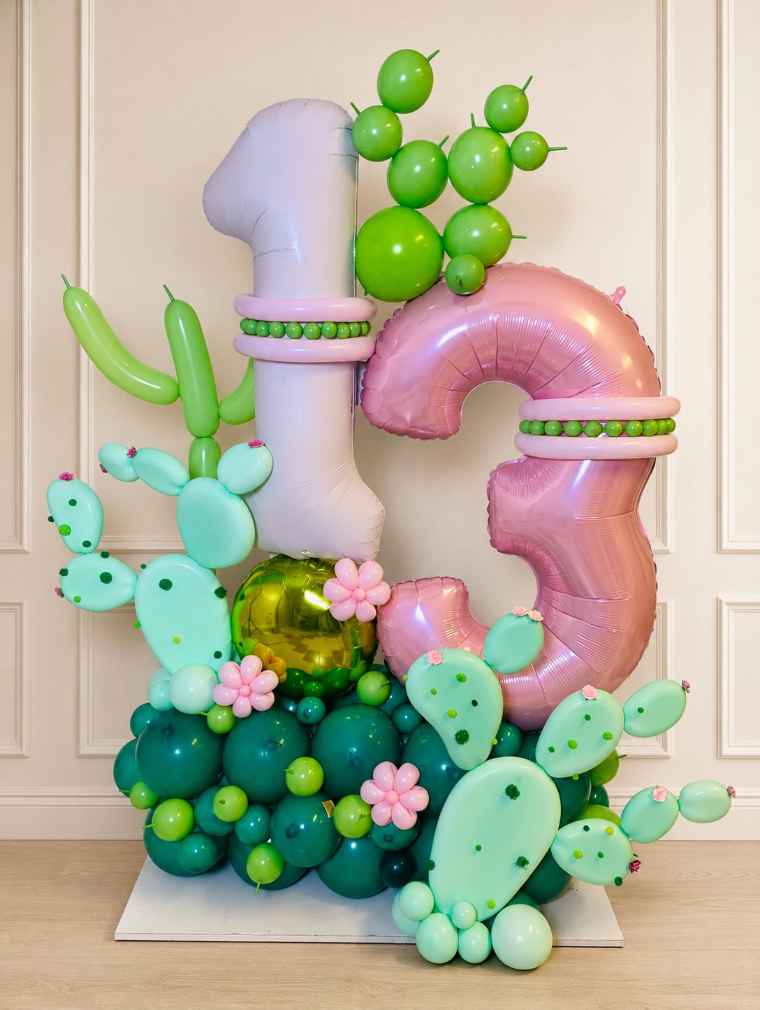 Luxury pink and green cactus-themed 13th birthday number balloon display with sculptural floral details in Toronto