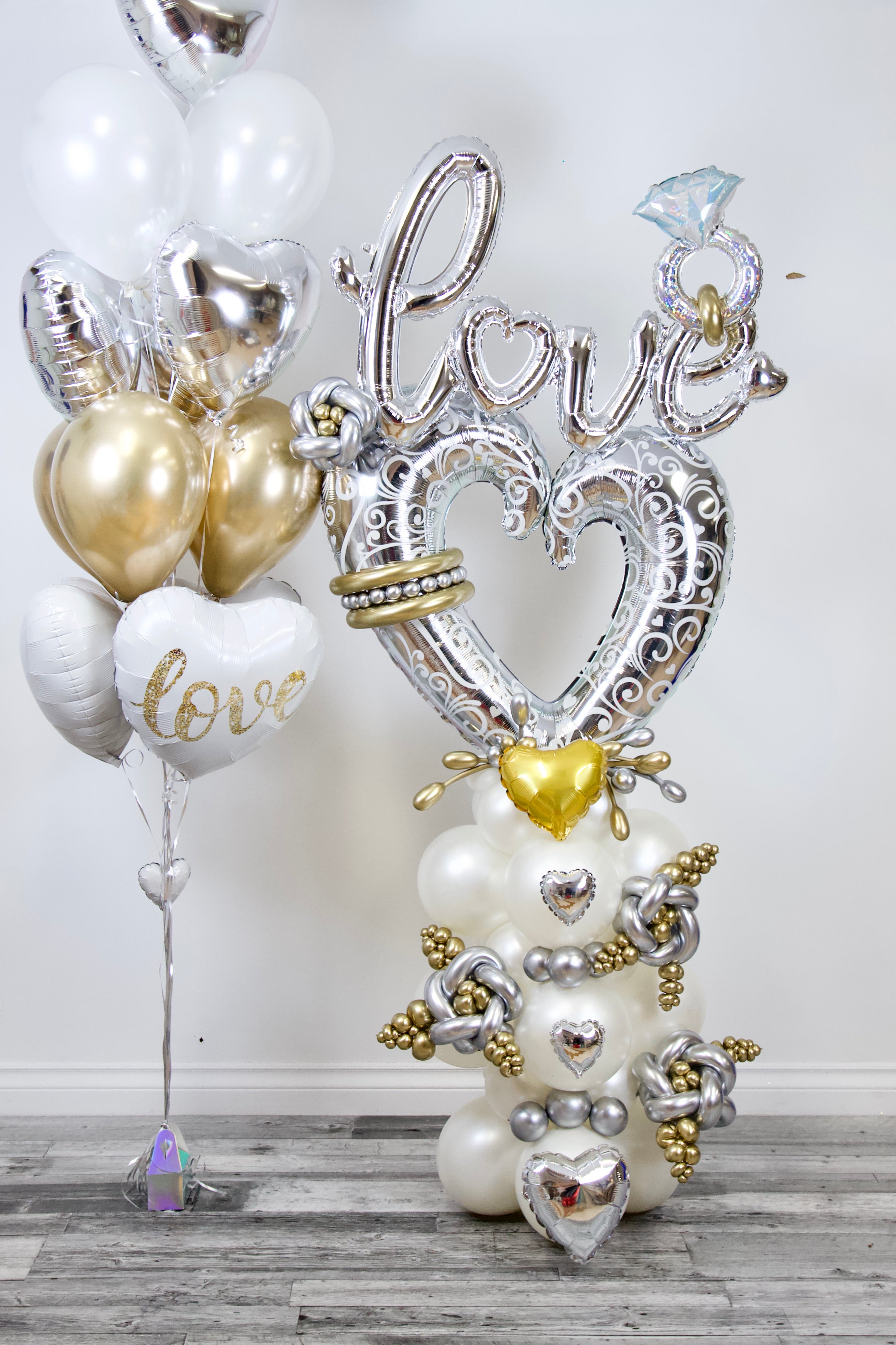 Luxury engagement balloon decor with silver “Love” balloons, heart balloons and diamond ring balloon for proposals and romantic celebrations in Toronto.