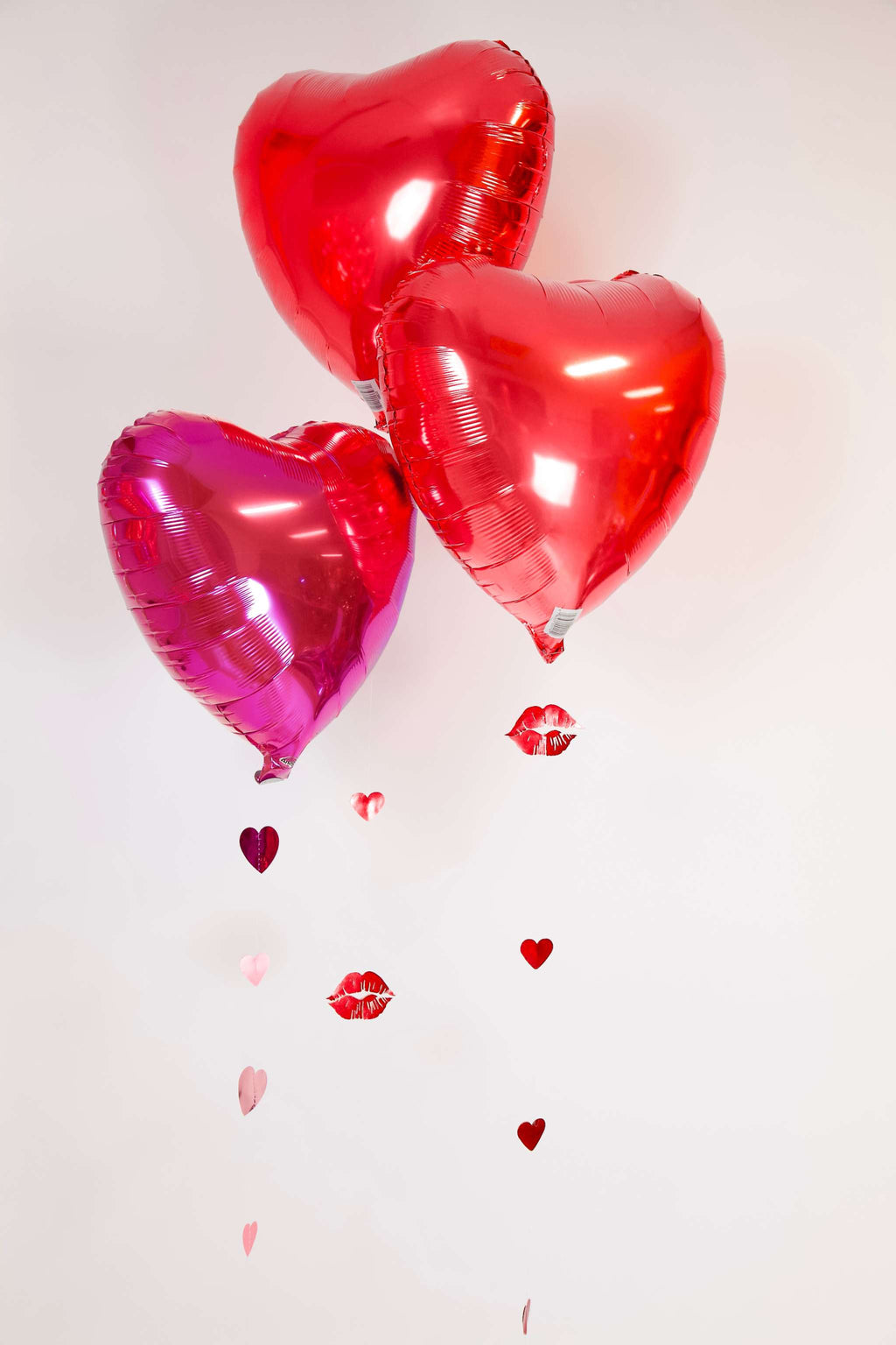 Floating Heart Balloon Trio with red and pink heart foil balloons, hanging hearts, and kiss accents for romantic decor in Toronto