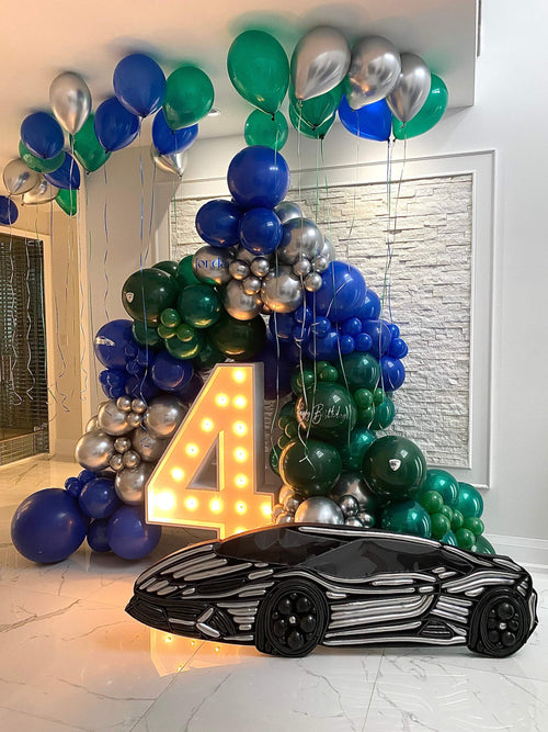 Luxury birthday balloon setup with balloon arch, LED number, and mosaic balloon car in Toronto