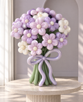 Lavender daisy balloon flower bouquet with pink and ivory blooms, green stems and a lilac bow