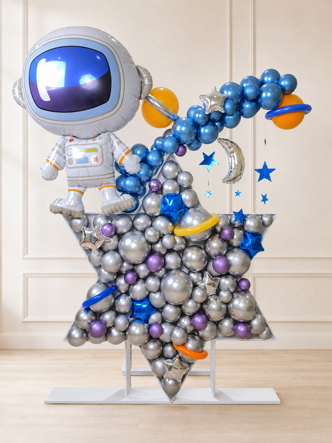 Luxury astronaut star balloon installation with metallic silver, cobalt blue and purple balloons for a space-themed Toronto event