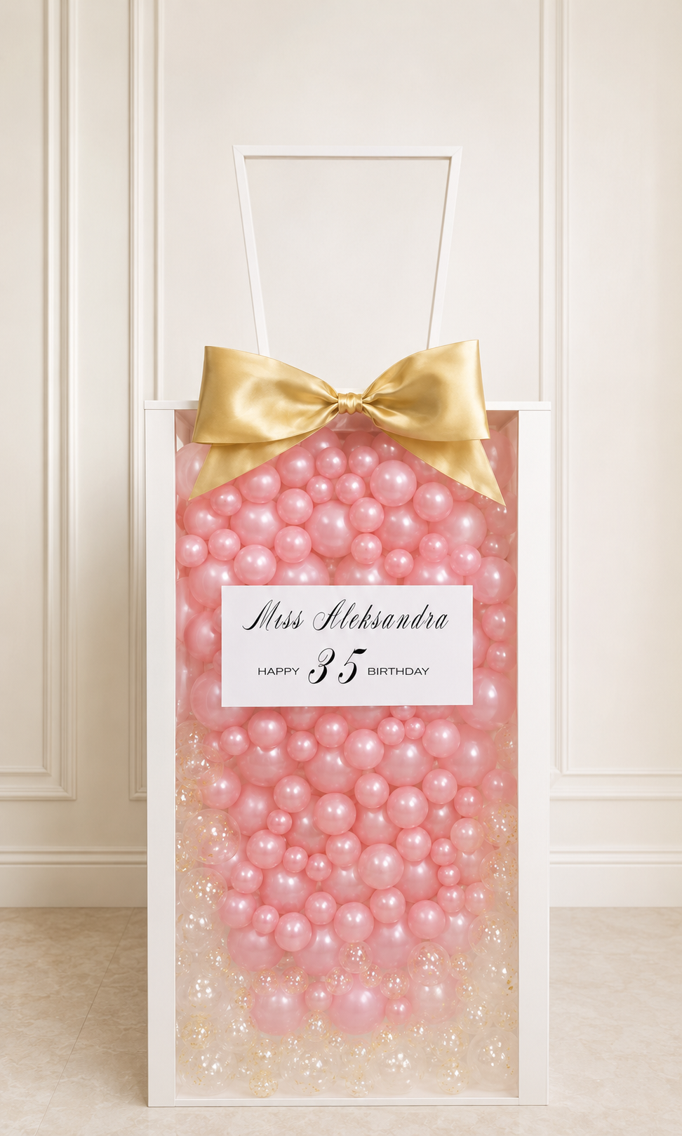 Luxury personalized balloon gift box with pearl mini balloons, clear confetti, oversized satin bow, and custom name on white frame display box