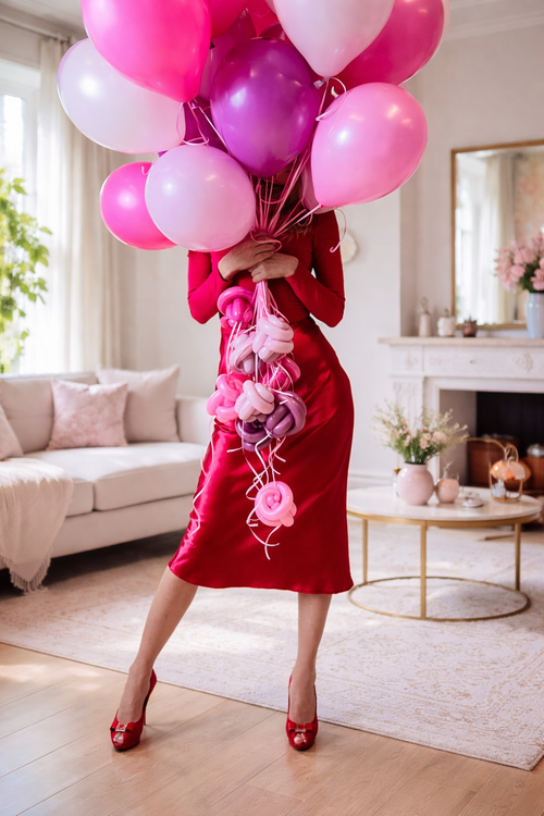 Luxury pink helium balloon bouquet held by woman in elegant red dress for romantic celebrations and balloon delivery in Toronto.
SEO