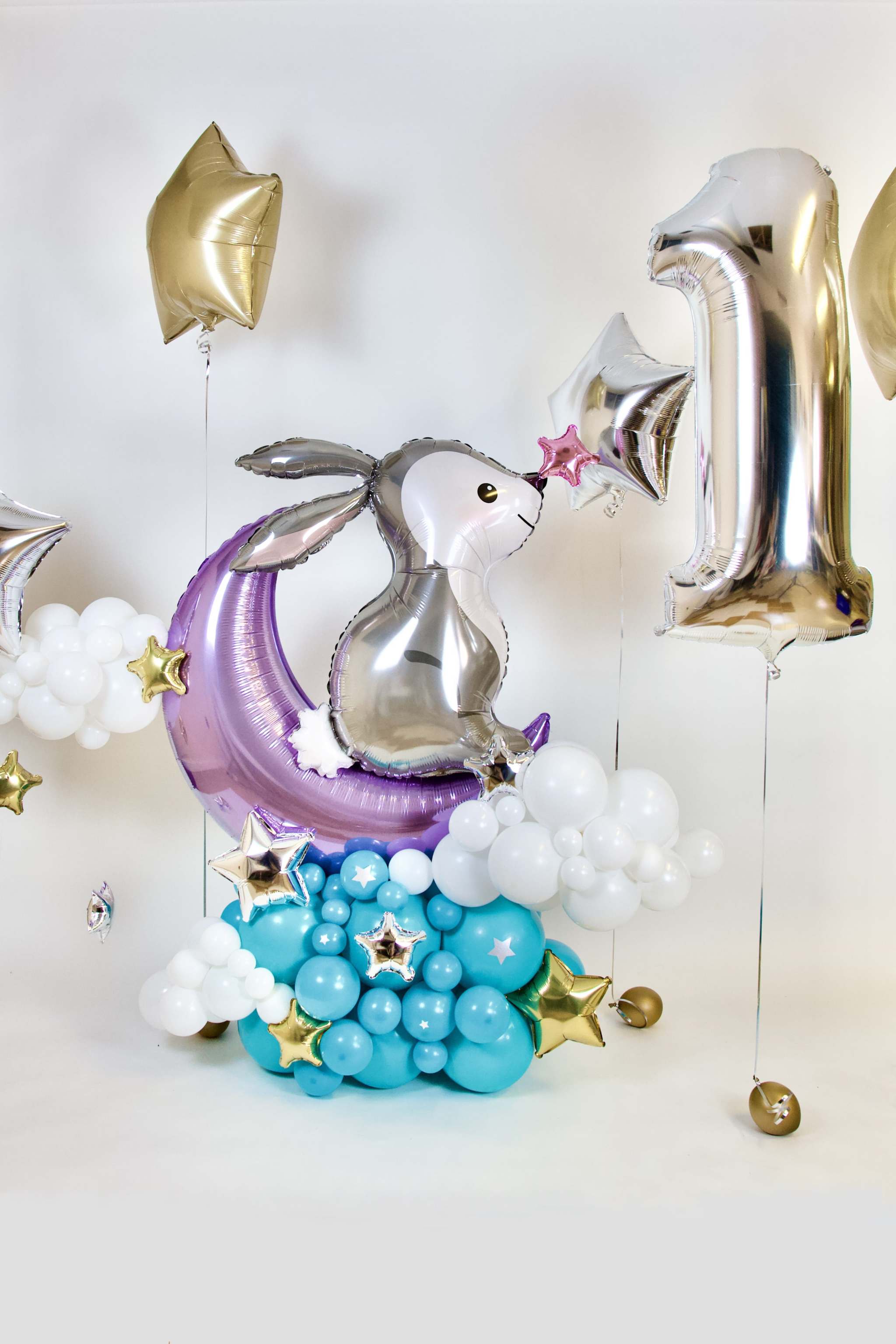 Moon and bunny birthday balloon display with silver bunny, metallic age number, clouds and turquoise balloon base
