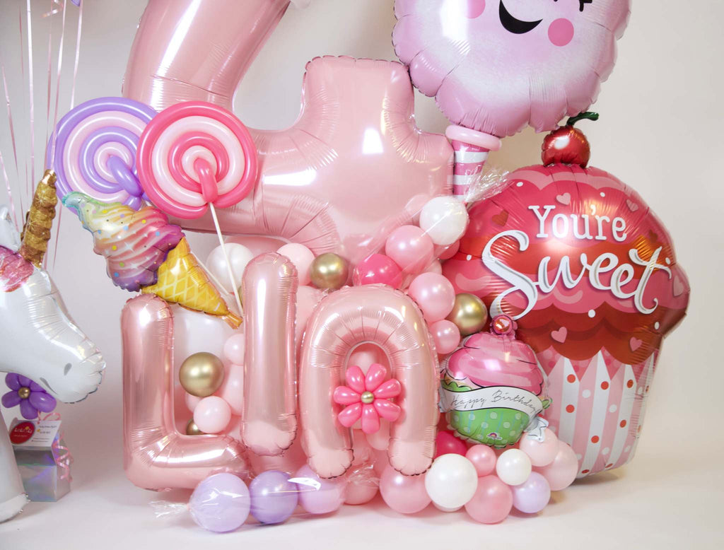 Sweet princess candy birthday balloons with custom age number, pastel balloon bouquet, cupcake balloon, unicorn, and Toronto party decor
