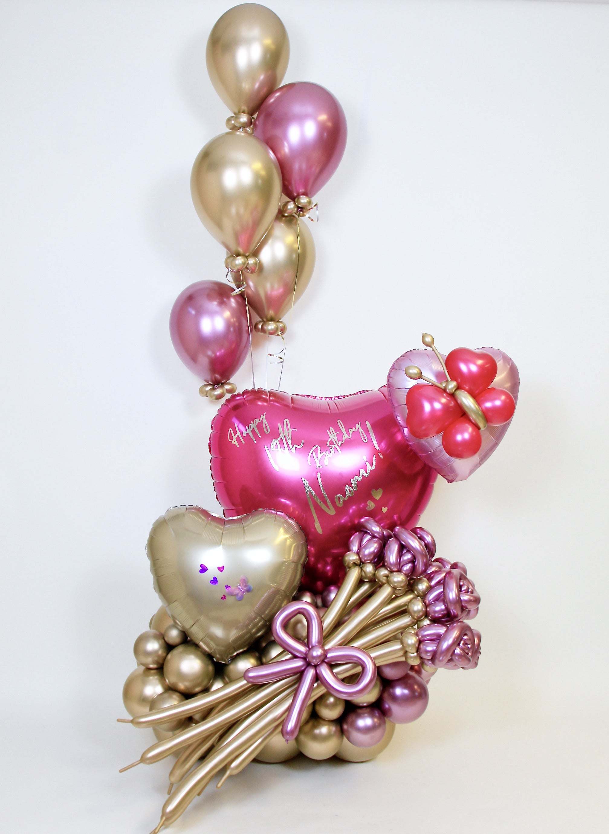 Personalized pink heart birthday balloon arrangement with handcrafted balloon flowers and gold details