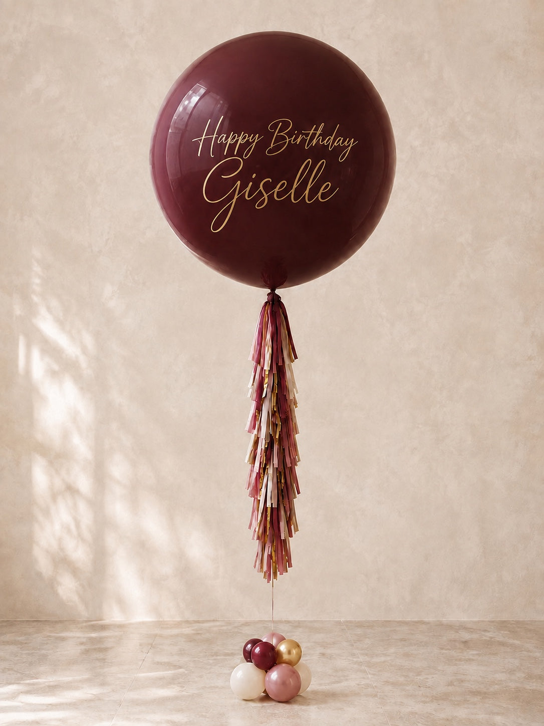 3 ft personalized burgundy jumbo birthday balloon with gold script lettering and tassel tail