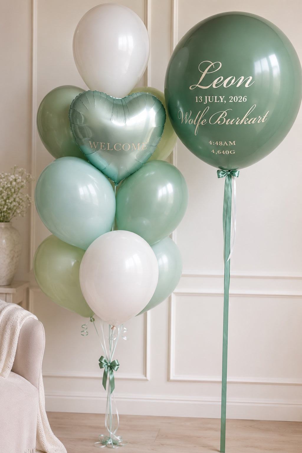 Personalized welcome baby balloon bouquet with mint, sage, and ivory balloons featuring baby's name and birth details