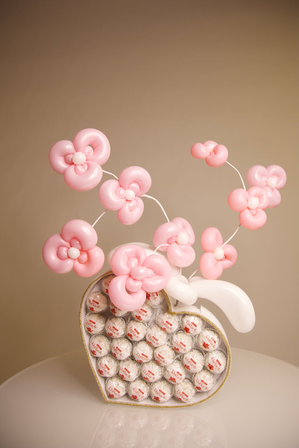 Heart-shaped Raffaello chocolate gift box with handmade pink balloon flowers for romantic gifts