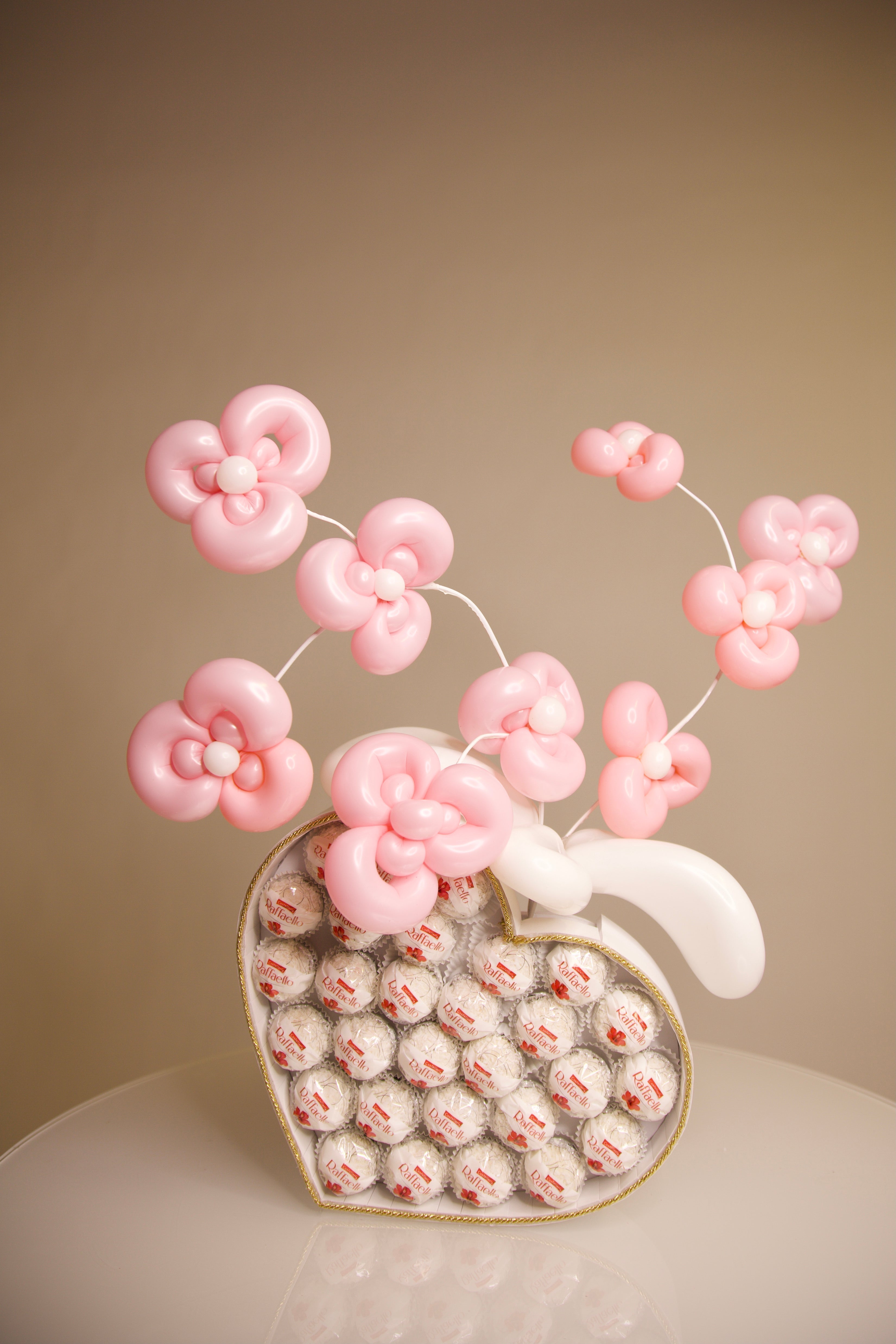Heart-shaped Raffaello chocolate gift box with handmade pink balloon flowers for romantic gifts