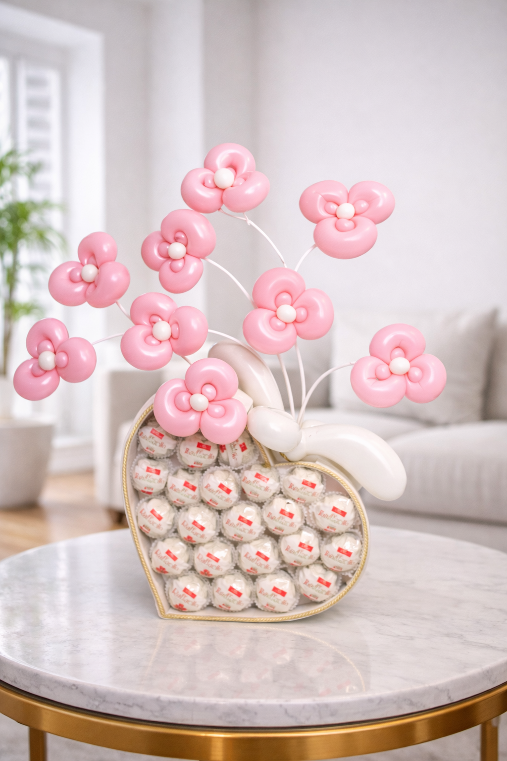 Raffaello chocolate gift arrangement with pink balloon flowers in decorative heart box for romantic gift delivery in Toronto.