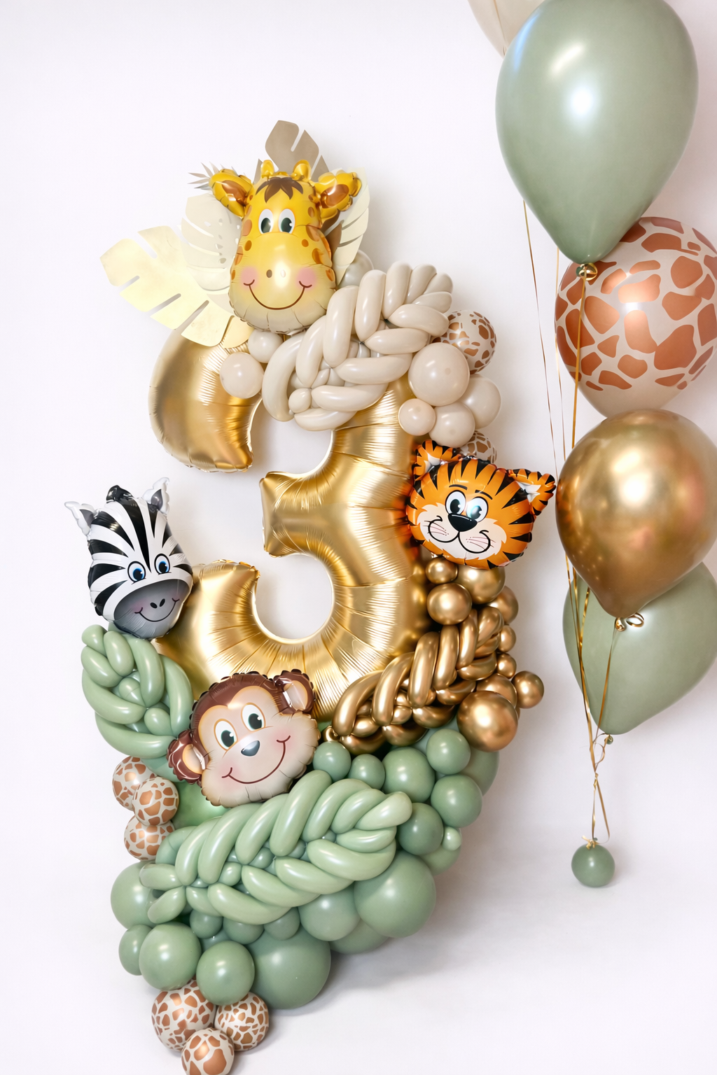 Jungle birthday balloon stack with giraffe tiger monkey balloons