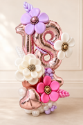 Rose-gold 18th birthday number balloon display with sculptural pink, lavender and ivory balloon flowers in Toronto