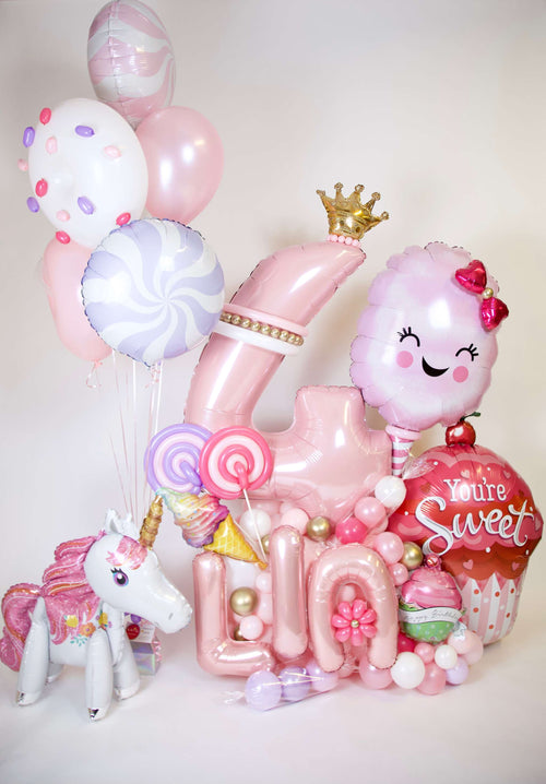 Candyland Birthday Balloons with custom number balloon, cotton candy balloon, unicorn, lollipops, cupcake accent, and pastel party decor