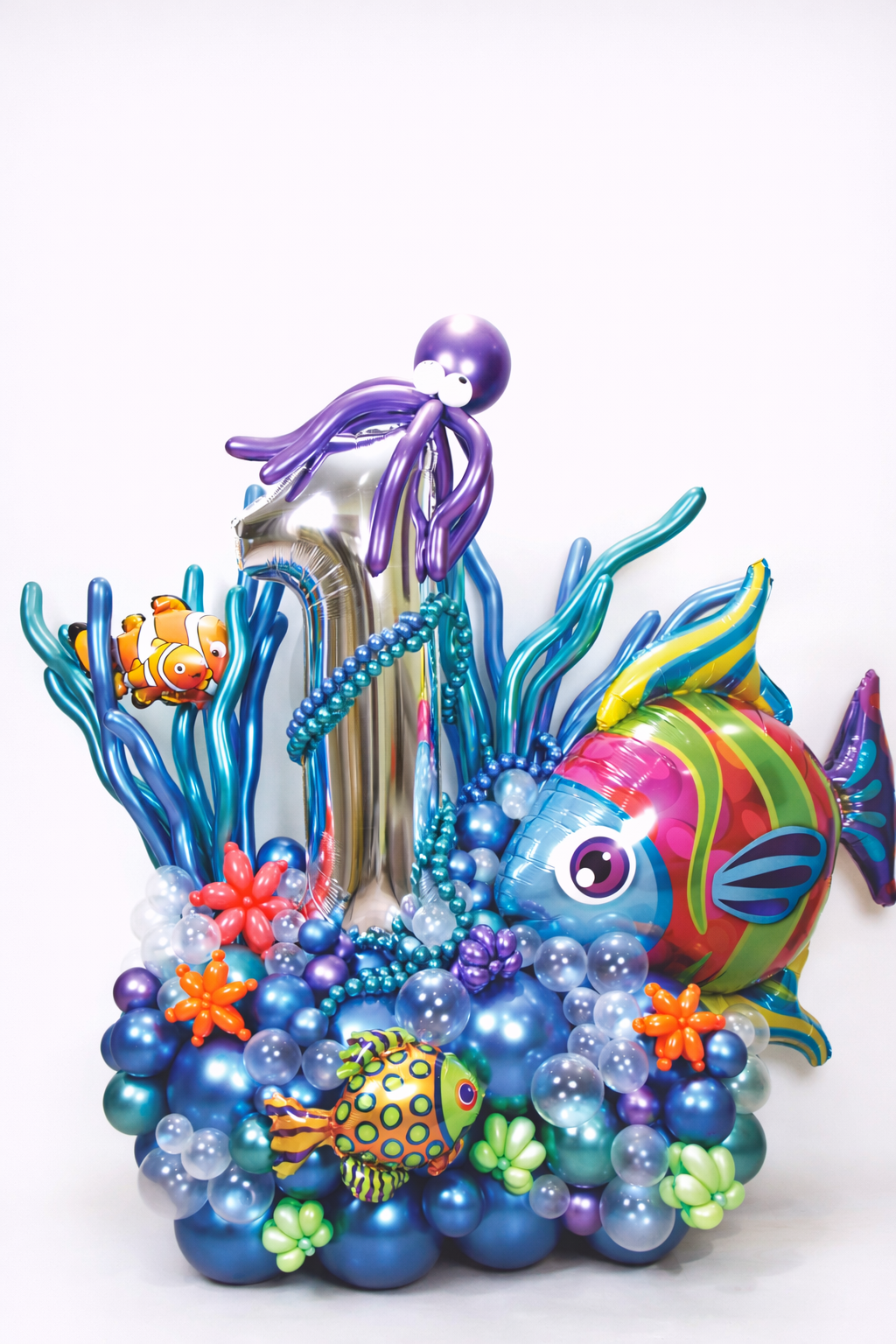 Under the sea first birthday balloon decoration with fish and octopus balloons
Ocean theme birthday balloon stack with sea animals and number balloon